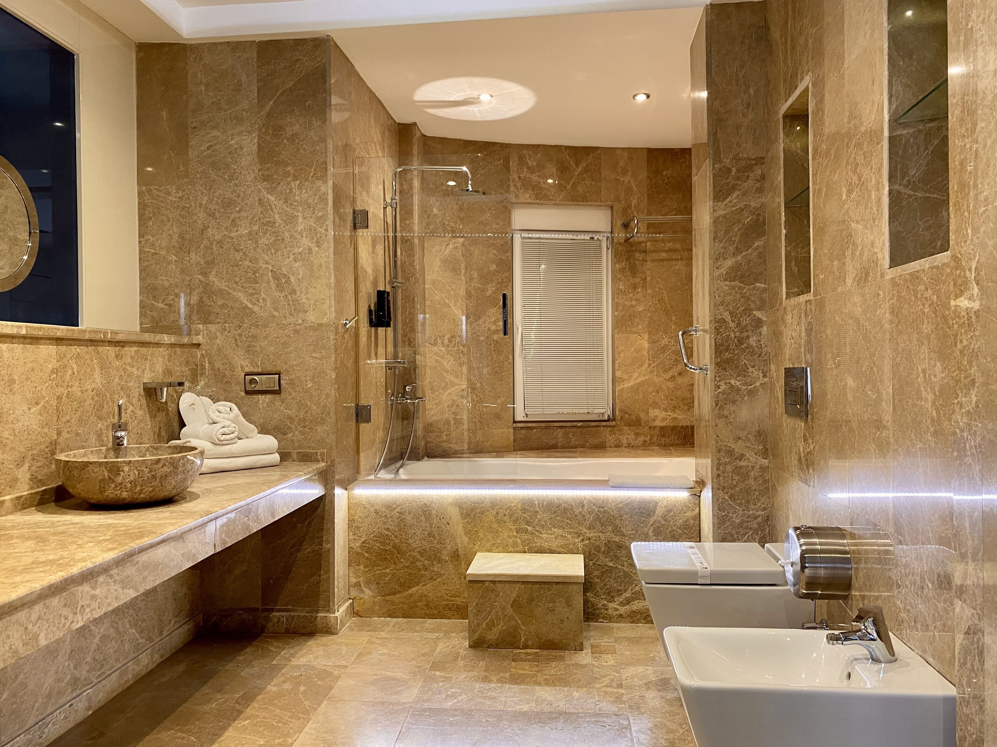 exclusive studio suite, jetted tub, city view | bathroom | designer toiletries, hair dryer, slippers, towels