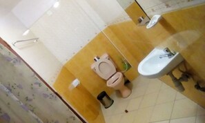 A bathroom with a toilet, bidet, and sink. - Marvin Hotel (Nakuru)