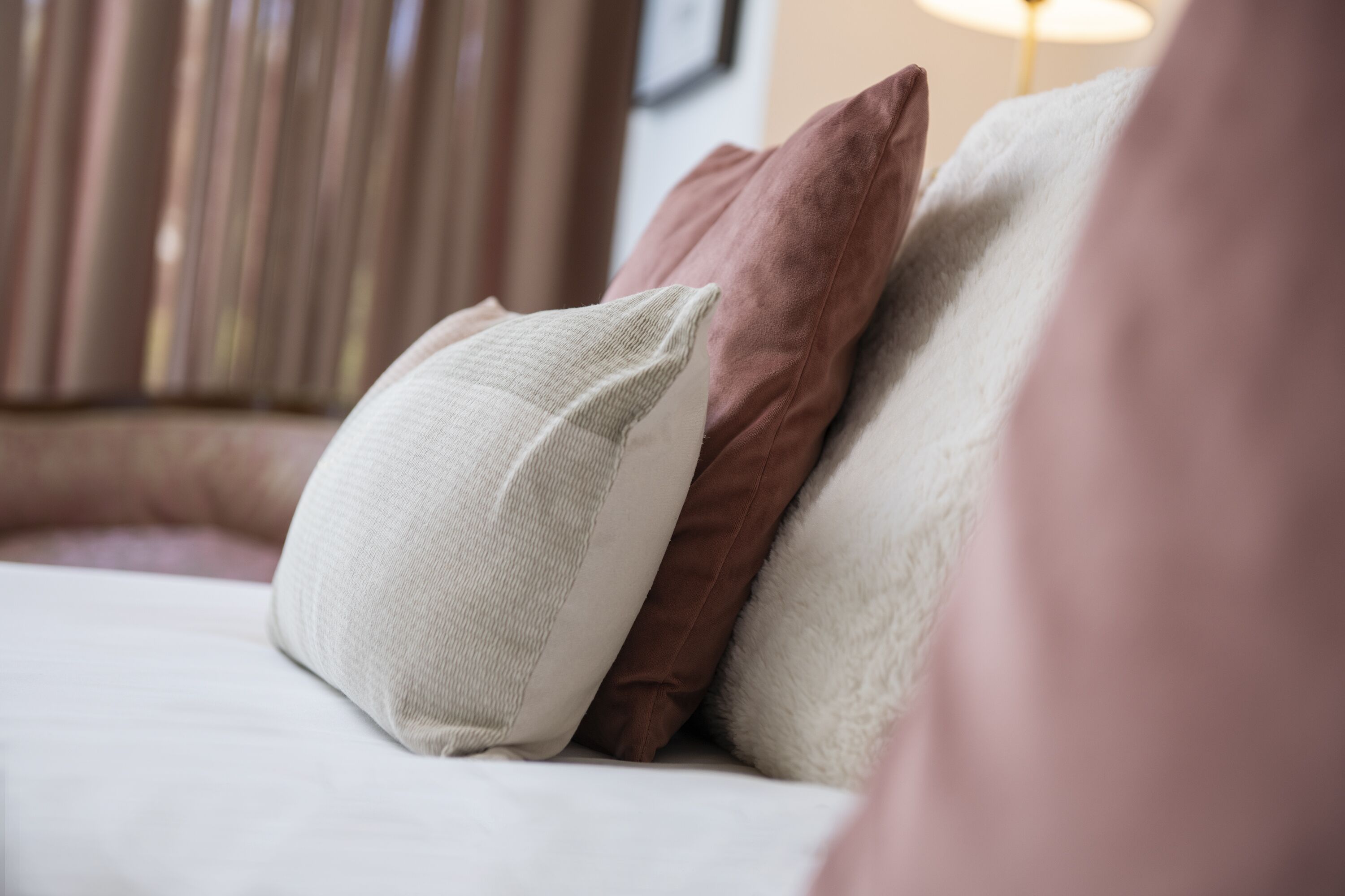 A close-up of a bed with pillows and a blanket.