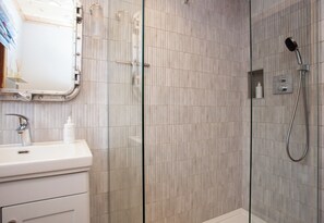 Bañera con ducha, secador de pelo, toallas, jabón