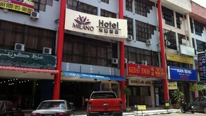 A hotel with a prominent sign, multiple air conditioning units, and a red pillar. - Milano Hotel (Kluang)