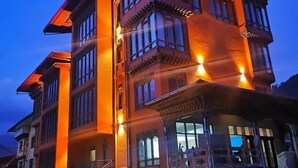 Un edificio de varios pisos con un estilo arquitectónico tradicional, que cuenta con amplios ventanales y un balcón.