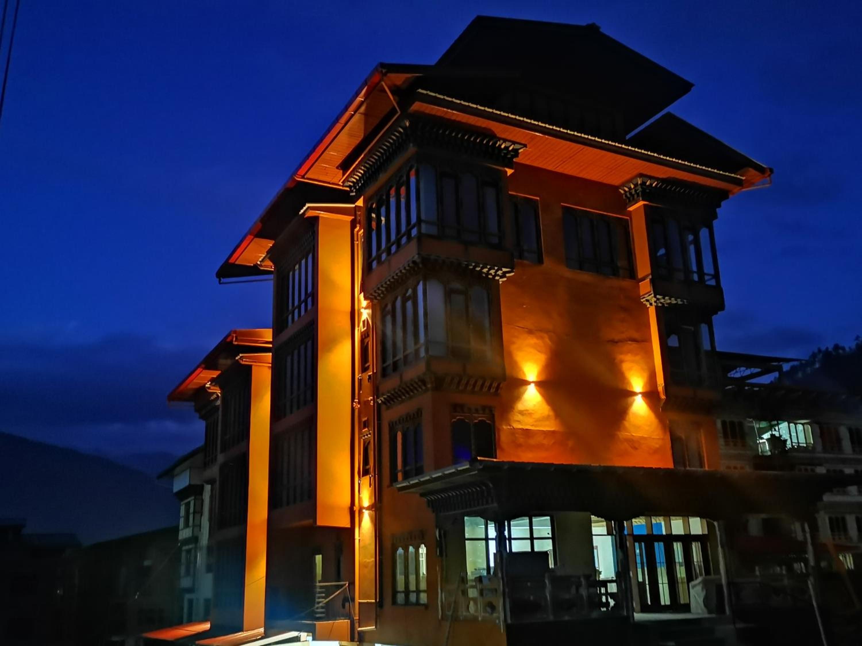 A multi-story building with a prominent entrance and a balcony.