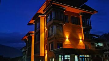 A multi-story building with a prominent entrance and a balcony.