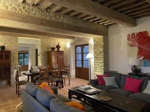 A rustic living room with stone walls, wooden furniture, and a stone fireplace. - Villa on Umbria Tuscany border, sleeps 12, stunning infinity pool superb views, (Montone PG)