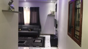 A modern living room with a sofa, TV, and decorative items. - F2 UDDERS AT MAYAA (Ngor)