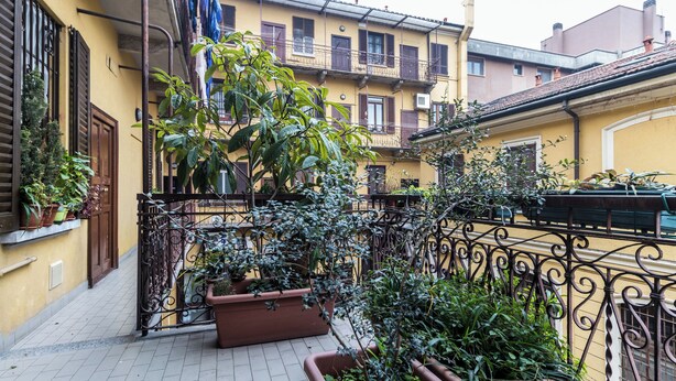 A balcony with potted plants and a wrought iron railing. - Italianway - Massarani 5 (Milan)