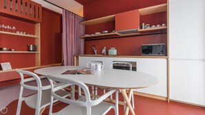 A modern kitchen with white cabinets, a microwave, and a coffee maker on the countertop. - Italianway - Bassini 31 (Milan)