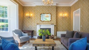 A living room with a fireplace, two sofas, a coffee table, and a chair. - Timoleague West Cork Priory House  (Cork)