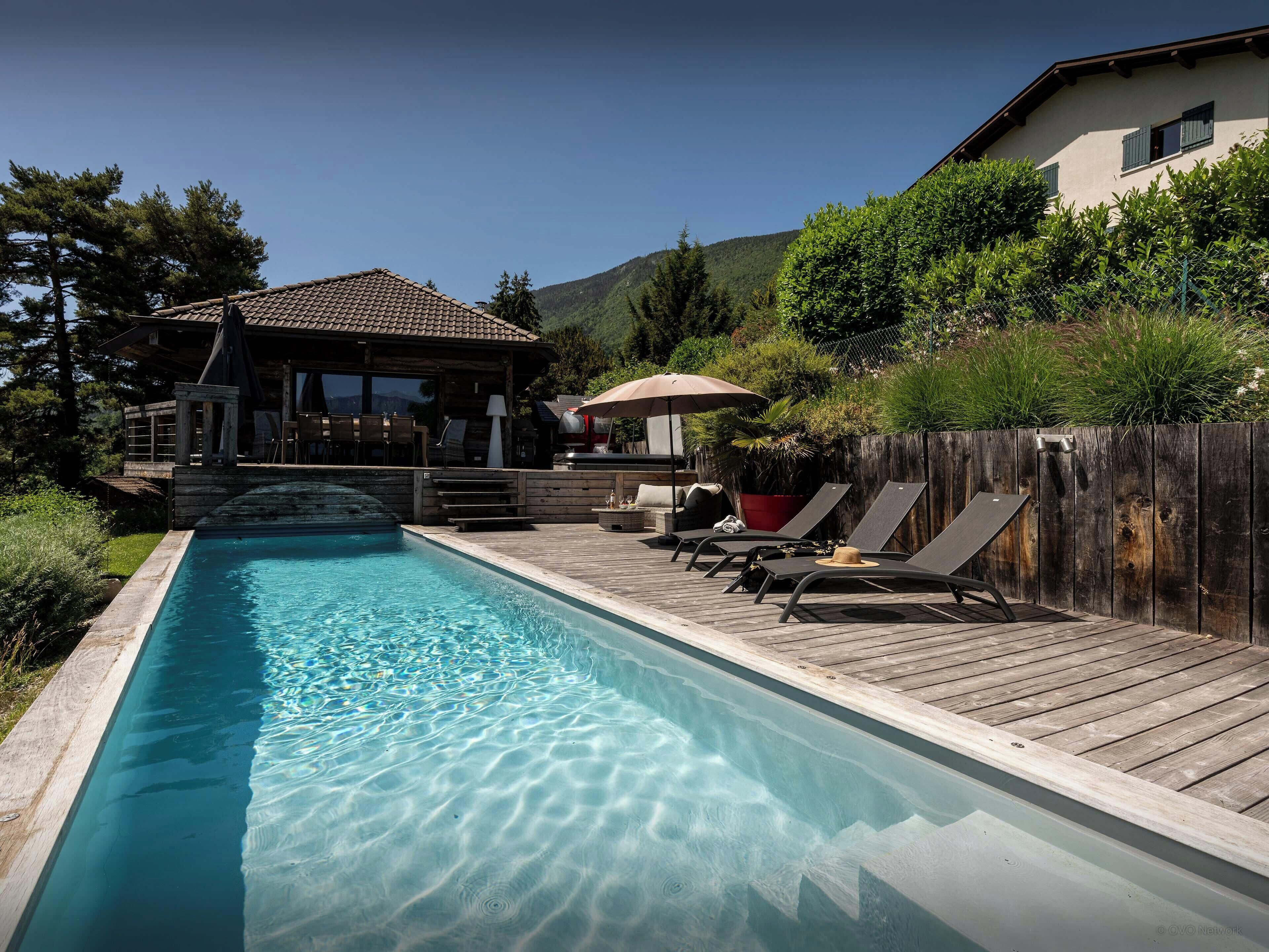 A heated pool, sun loungers
