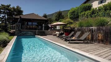A heated pool, sun loungers
