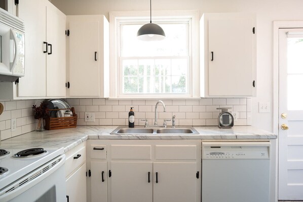 Enjoy cooking in this well-equipped kitchen with a double sink, oven, and dishwasher.