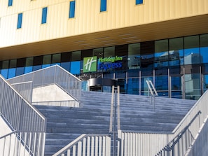 A modern building with a Holiday Inn Express sign, featuring a staircase with metal railings and a glass facade. - Holiday Inn Express Nice Grand Arenas by IHG (Nice)