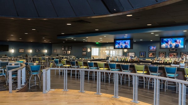 A spacious bar area with multiple seating arrangements and a bar counter.