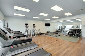 A gym with treadmills, elliptical machines, and free weights. - Holiday Inn Express & Suites Charlotte Southwest by IHG (Charlotte)