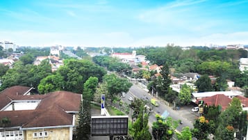 A residential area with houses, trees, and a road.