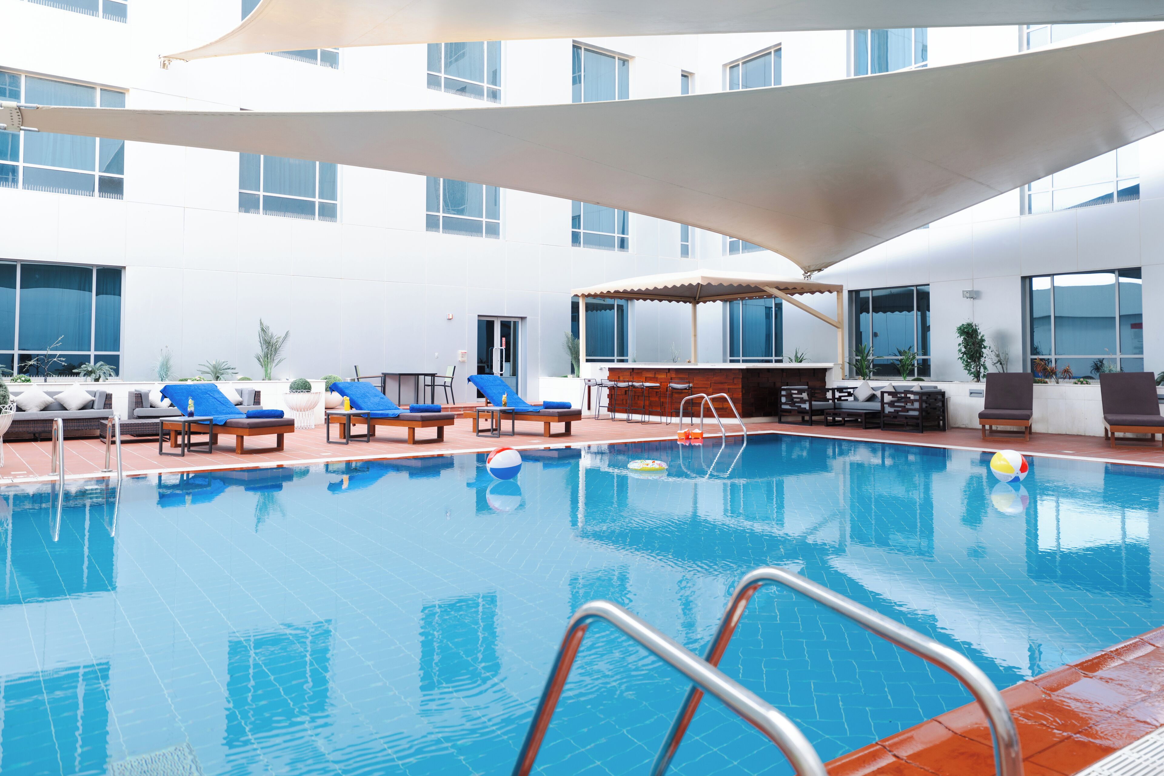 outdoor pool, open 7:00 am to 6:00 pm, pool loungers
