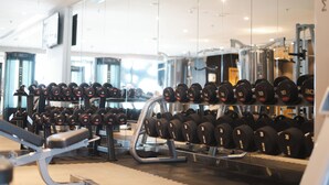 A gym with various weightlifting equipment, including dumbbells and benches. - ibis Jeddah City Center (Jeddah)