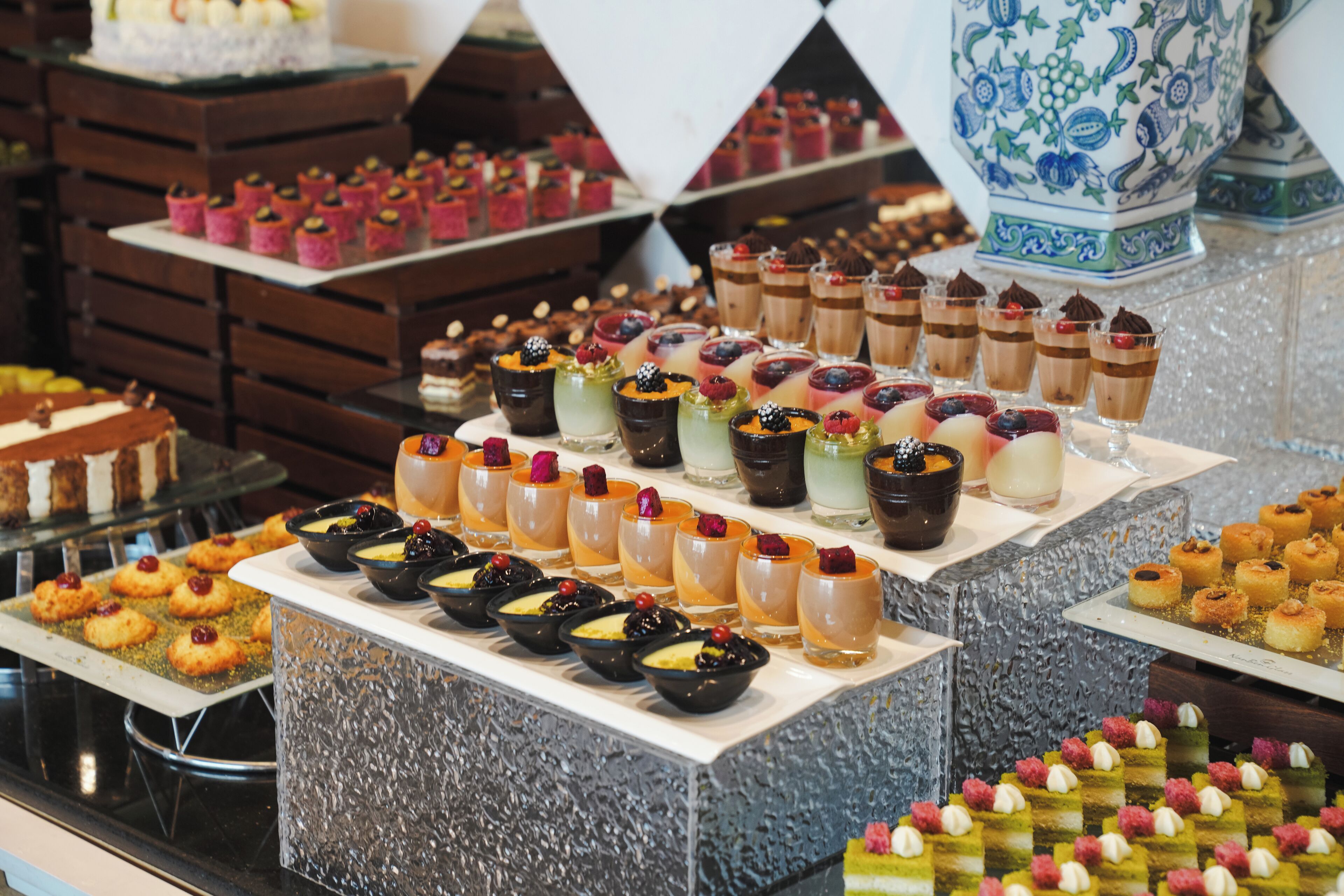 A variety of desserts and pastries displayed on tiered stands.