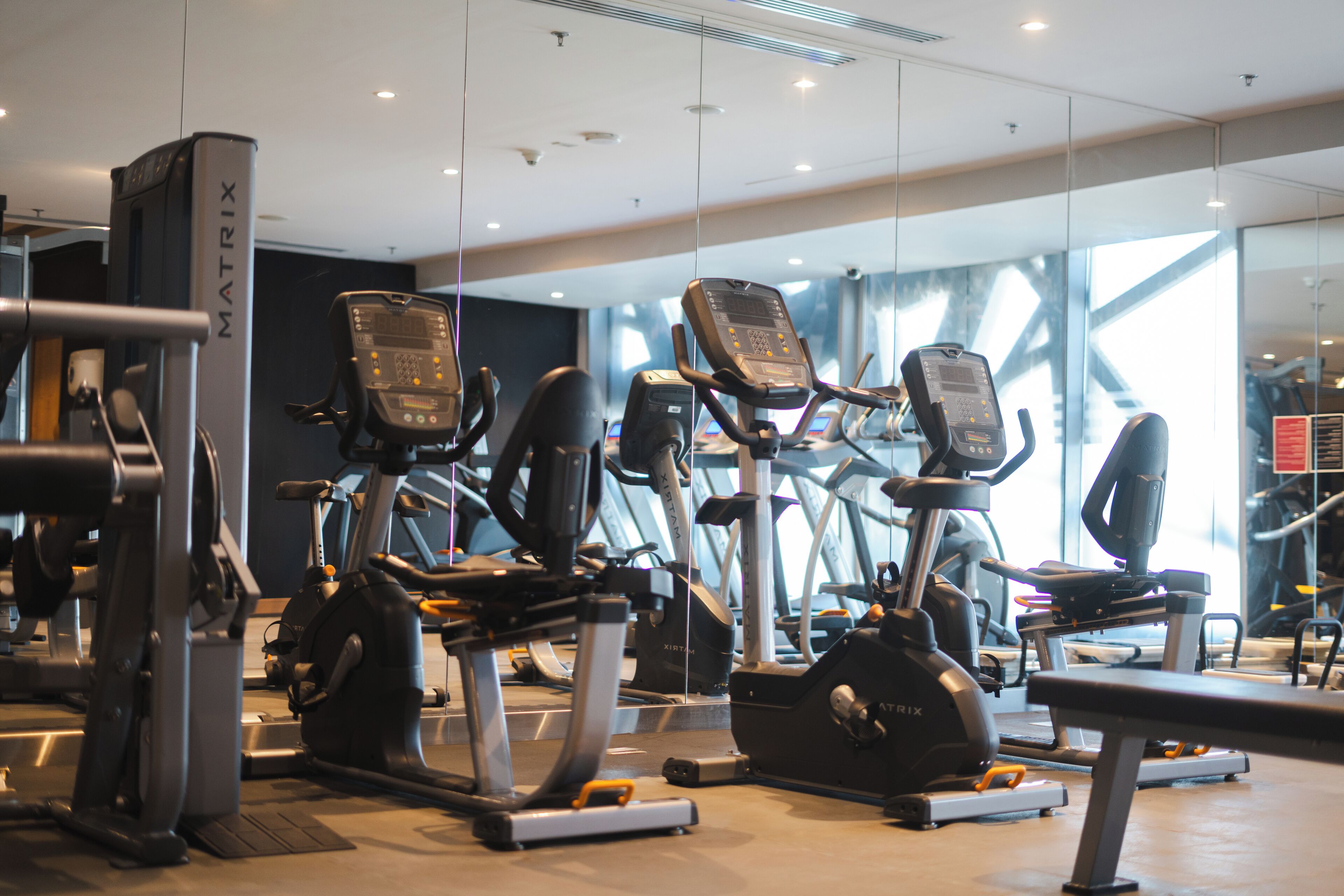 A gym with multiple treadmills and exercise equipment.