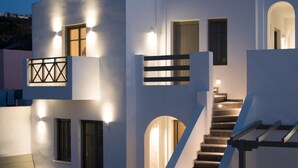 A modern two-story building with a staircase leading to the upper floor. - Amphitrite Suites Santorini (Santorini)