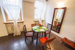 Enjoy meals with family and friends at this cozy dining area, featuring a round table and comfortable seating for four.