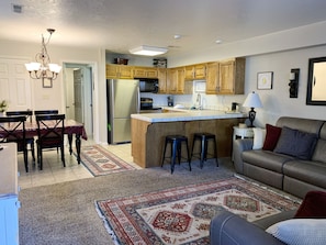 Cozy living space with a kitchen area, dining table, and comfortable seating.