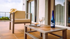 A balcony with a table, a chair, a magazine, two wine glasses, and a bottle. - Casa Adela with private pool on walking distance to Begur. (Begur)