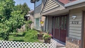 A residential house with a number 8320 on the door, a front porch with potted plants, and a white picket fence. - SPACIOUS. QUIET ROOM W PRIVATE BATHROOM IN GREAT HOUSE (Richmond)