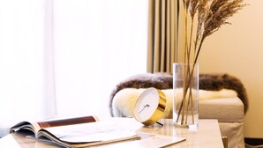 A clear view of a room with a bedside table, a book, a clock, and a vase with dried plants. - City Hotel Namba Ⅱ (Osaka)