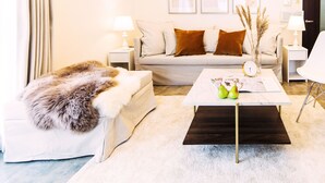 A modern living room with a sofa, a coffee table, and a lamp. - City Hotel Namba Ⅱ (Osaka)
