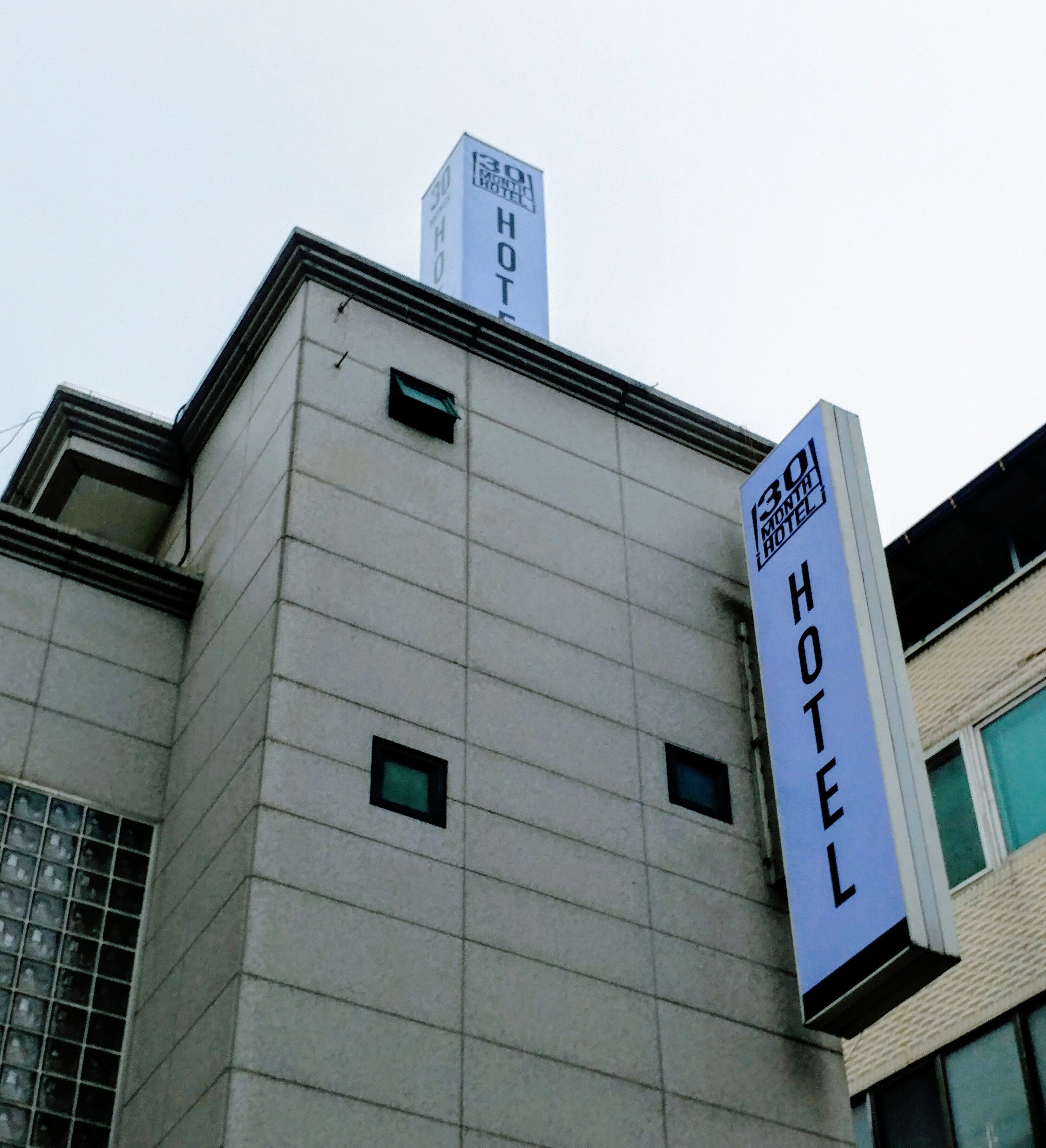 A building with a sign that reads "30 Month Hotel."