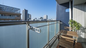 A balcony with a view of a cityscape, including tall buildings and a clear sky. - City Hotel Shinsaibashi (Osaka)