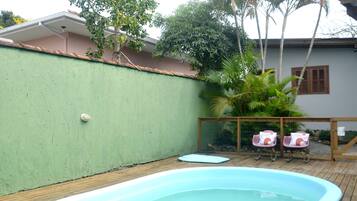 Outdoor pool, open 10:00 AM to 7:00 PM, pool umbrellas, pool loungers