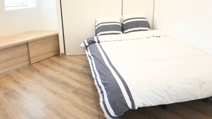 A bedroom with a bed, a bench, and a window. - Brand new studio located in the center of Paris (Paris)