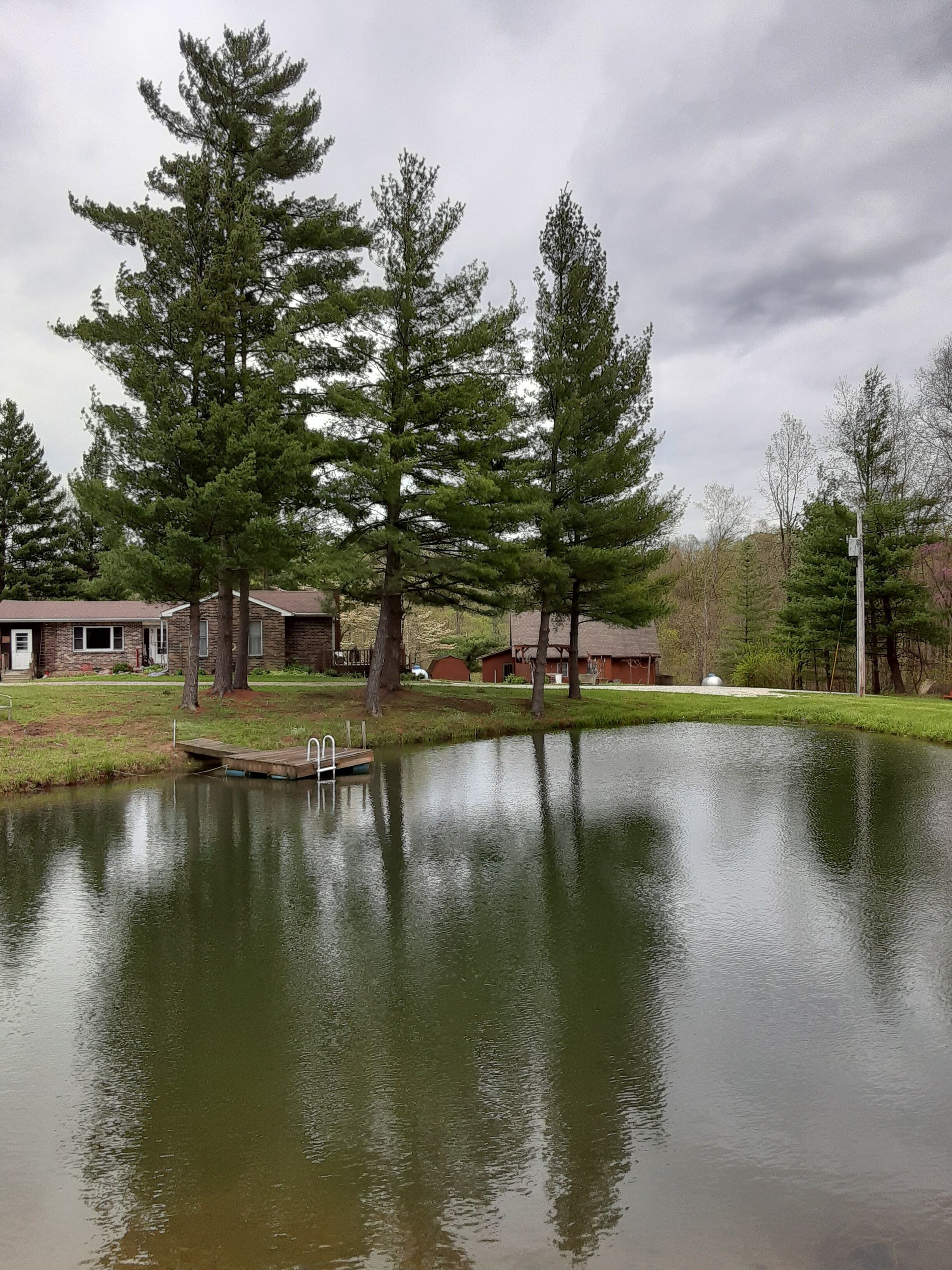 view of homes..brick house is owners home..wood home is cabin
