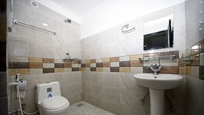 A bathroom with a toilet, sink, and shower. - Hotel Pancha Buddha (Kathmandu)