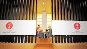 A restaurant interior with a traditional Japanese design, featuring a central table with two patrons. - Azalea Suites Cikarang by Jayakarta Grup (Cikarang)
