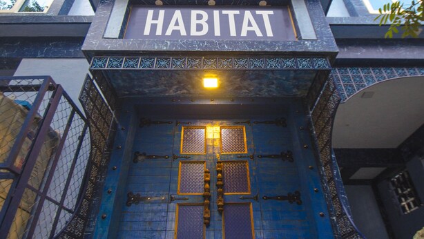 A building with a blue facade and a sign that reads "HABITAT". - Habitat by Liwa (Bengaluru)