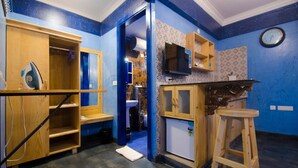 A compact kitchen with wooden cabinets, a microwave, and a sink. - Habitat by Liwa (Bengaluru)