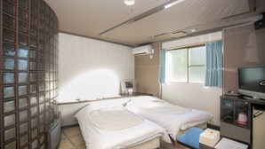 A hotel room with two beds, a television, a desk with a computer, and a window with curtains. - Kanku Kokusai Hotel (Wakayama)
