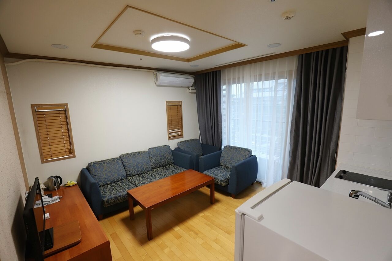 Family Quadruple Room | Living area | Flat-screen TV