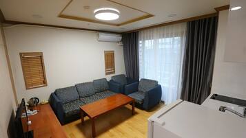 Family Quadruple Room | Living area | Flat-screen TV