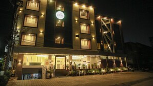 A hotel with multiple floors, a prominent sign, and a well-lit entrance. - Hotel Citrus Prime (Raipur)