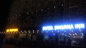 A building with a sign that reads "HOTEL SWARNA INN".