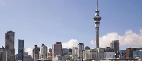 A cityscape with a prominent tower, various buildings, and a clear sky.