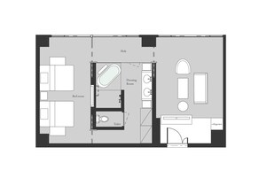 Plano de planta de una habitación de hotel con cama, vestidor, inodoro, televisor y refrigerador.