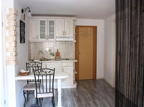 Fridge, stovetop, electric kettle, cookware/dishes/utensils