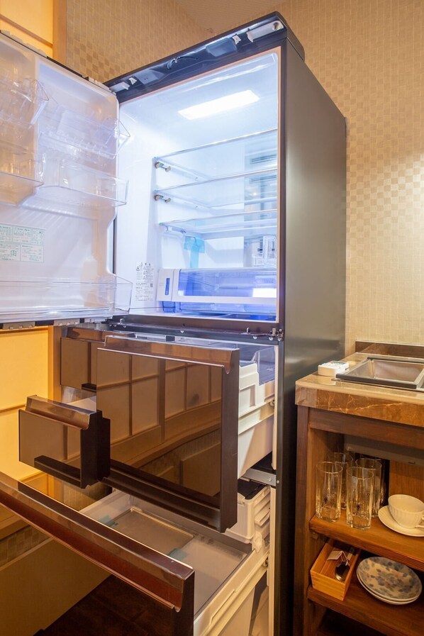 Kitchen area with refrigerator, water and ice dispenser, and ample storage.