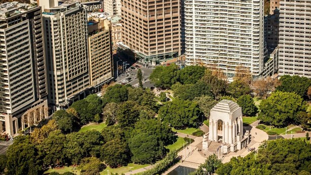 A high-rise building complex with a central courtyard featuring a monument. - Little New York on Riley (Darlinghurst)